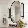 Овальное зеркало в черной раме “KVINDE” в ванной комнате